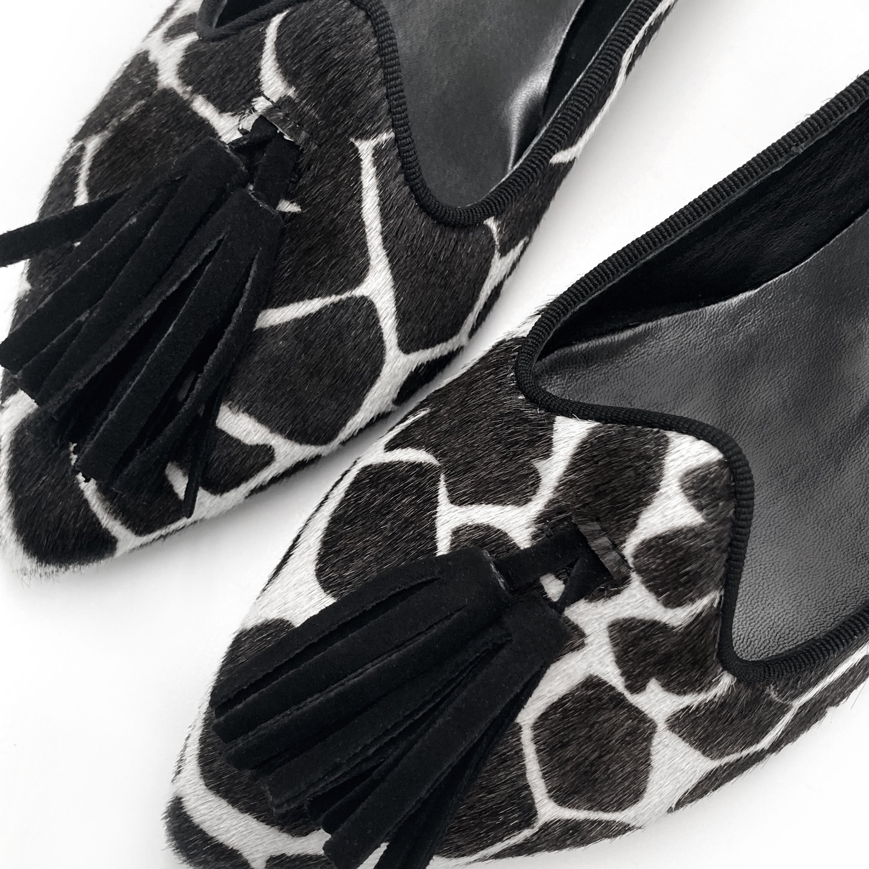 Women's black and white animal print pointed toe moccasins